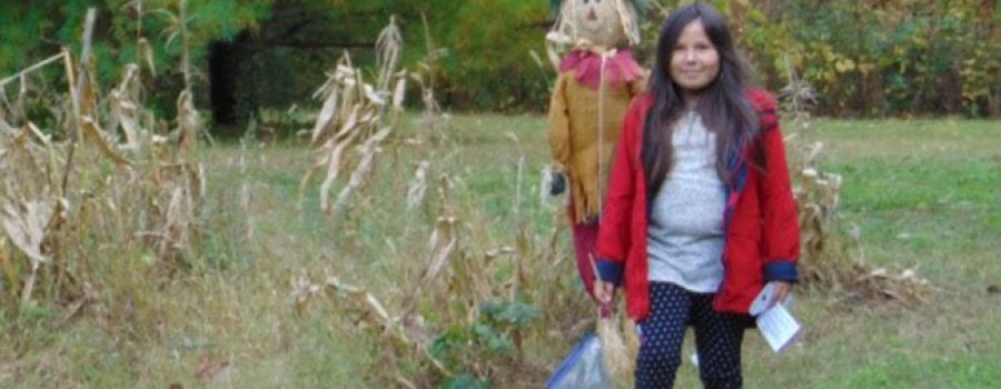 child with scarecrow