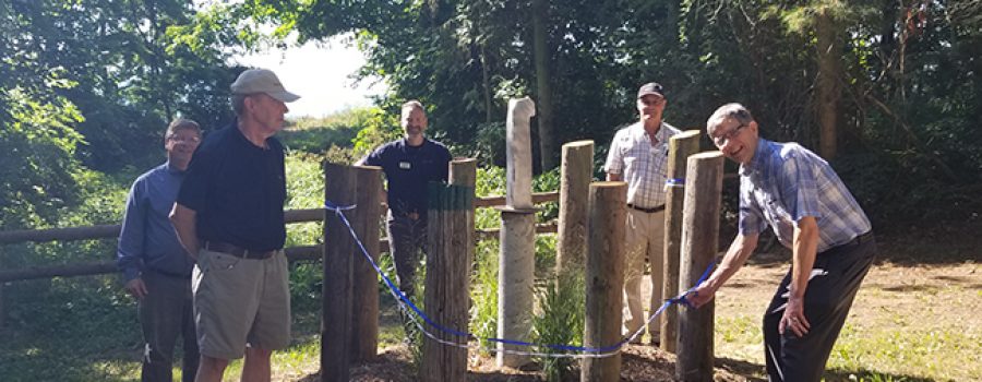 group cutting ribbon at E.M. Warwick Conservation Area "The Oluuc" sculpture unveiling August 13 2020