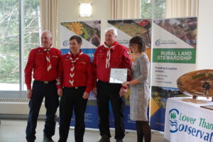 Three Boy Scout leaders receiving an award.